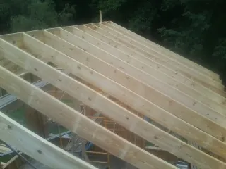 New roof rafters set over an addition before sheathing in Pataskala
