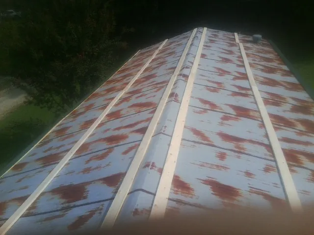 Rusted metal roof panels with new wood purlins before replacement — Storm Damage Roof Repair in Pataskala by Roofing Brothers